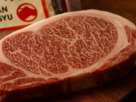 Side-by-side photo of raw Japanese Wagyu beef cuts from Japanese Black, Japanese Brown, and Japanese Shorthorn cattle, showing differences in marbling and texture.
